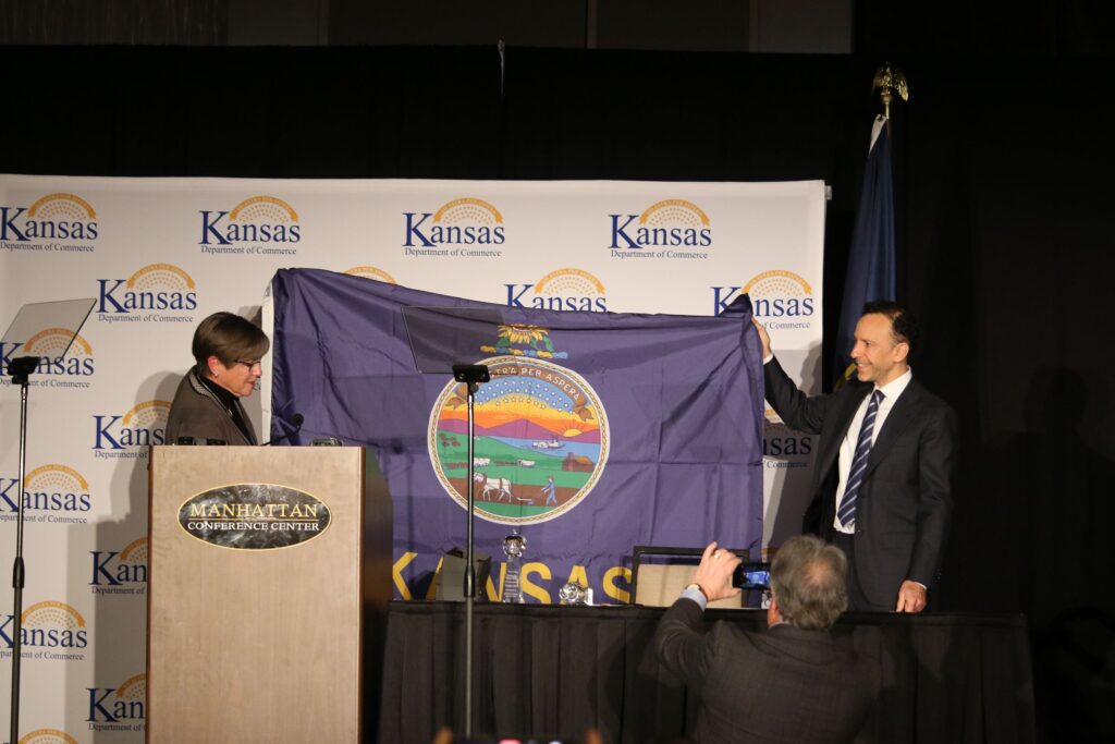 Governor Laura Kelly and the Kansas flag